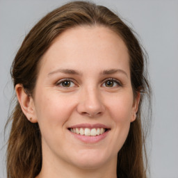 Joyful white young-adult female with medium  brown hair and brown eyes