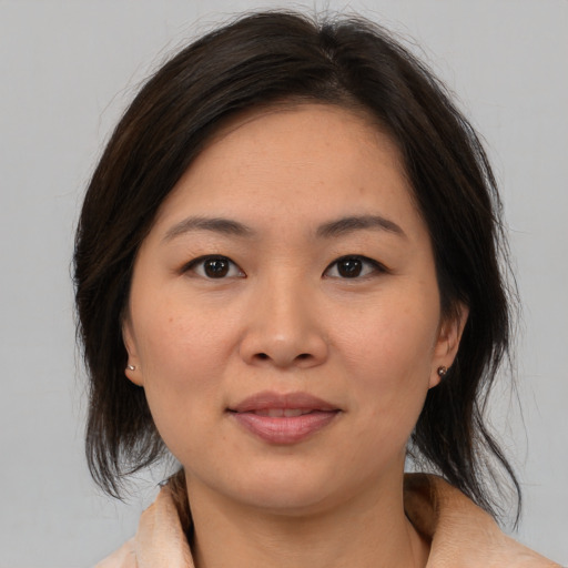 Joyful white young-adult female with medium  brown hair and brown eyes
