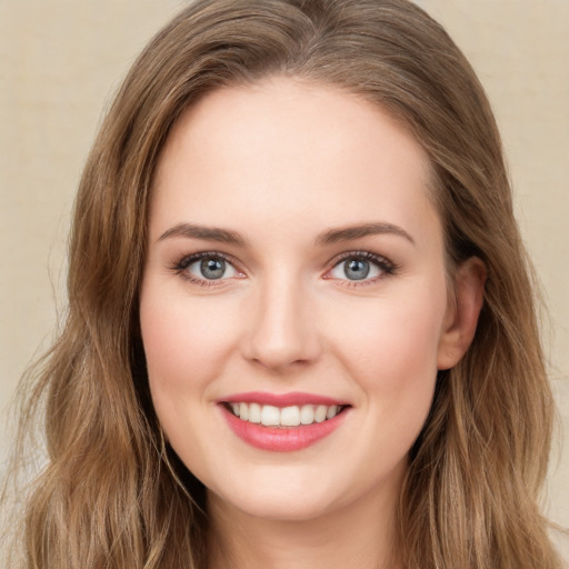 Joyful white young-adult female with long  brown hair and green eyes