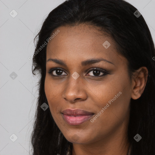 Joyful black young-adult female with long  black hair and brown eyes