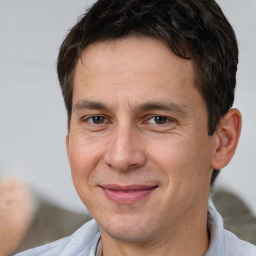 Joyful white adult male with short  brown hair and brown eyes