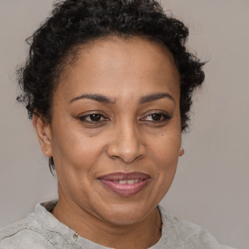 Joyful latino adult female with short  brown hair and brown eyes