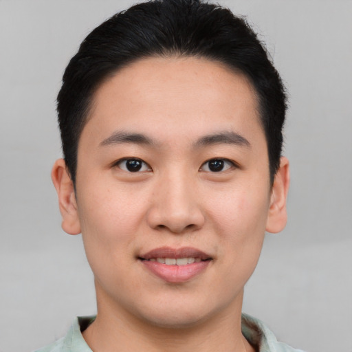 Joyful asian young-adult male with short  black hair and brown eyes