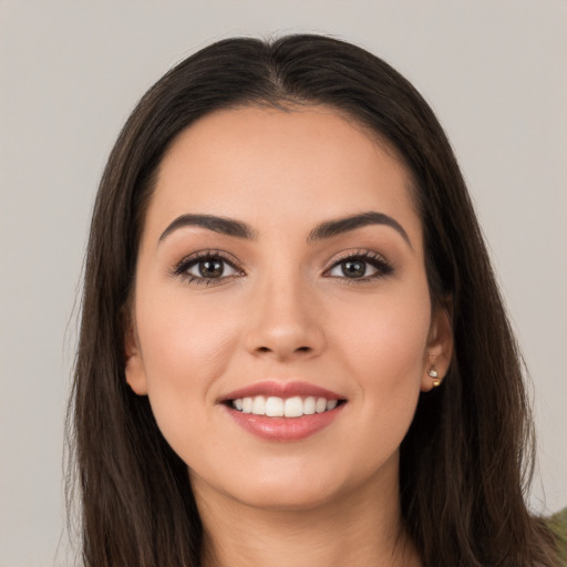 Joyful white young-adult female with long  brown hair and brown eyes