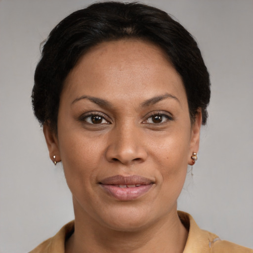 Joyful latino adult female with short  brown hair and brown eyes