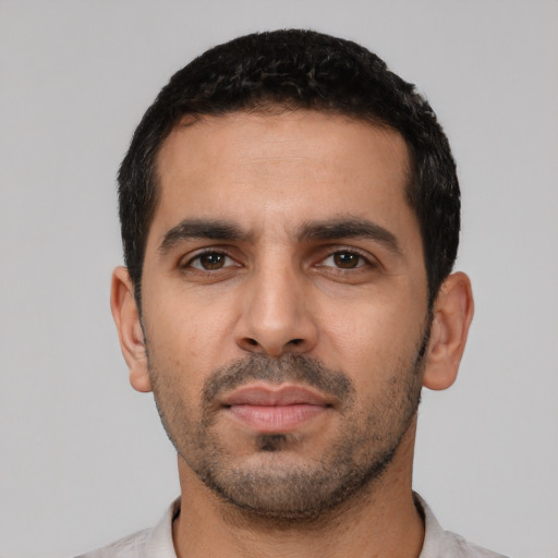 Neutral latino young-adult male with short  black hair and brown eyes