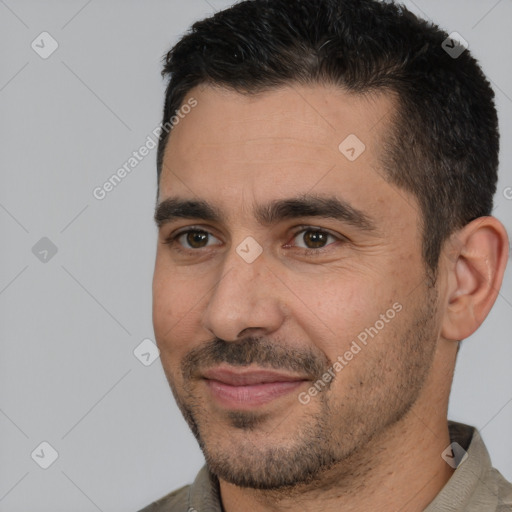 Joyful white adult male with short  brown hair and brown eyes