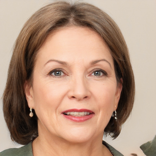 Joyful white adult female with medium  brown hair and grey eyes