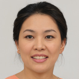 Joyful asian young-adult female with medium  brown hair and brown eyes