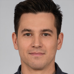 Joyful white young-adult male with short  brown hair and brown eyes