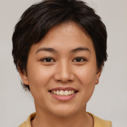 Joyful asian young-adult female with short  brown hair and brown eyes