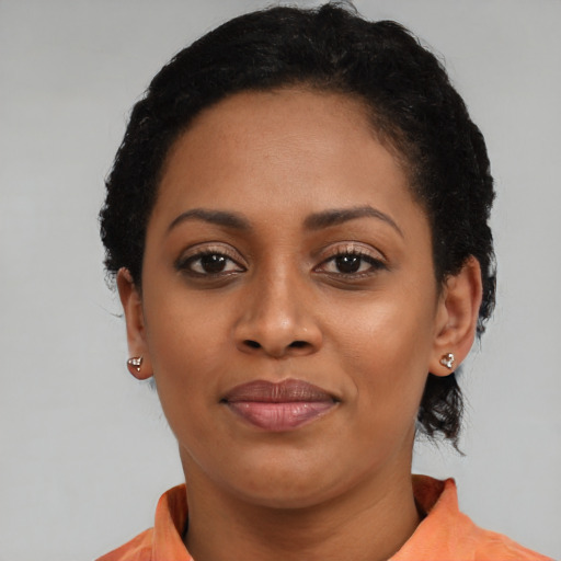 Joyful latino young-adult female with short  black hair and brown eyes