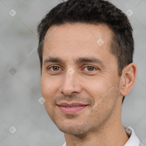 Joyful white adult male with short  brown hair and brown eyes