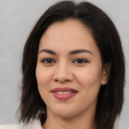 Joyful asian young-adult female with long  brown hair and brown eyes