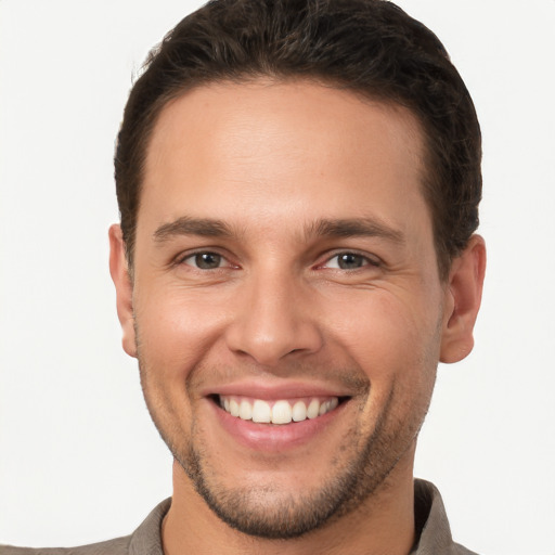 Joyful white young-adult male with short  brown hair and brown eyes