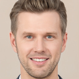 Joyful white young-adult male with short  brown hair and grey eyes