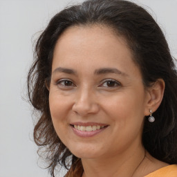 Joyful white adult female with long  brown hair and brown eyes