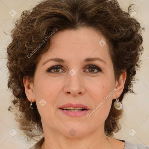 Joyful white adult female with medium  brown hair and green eyes