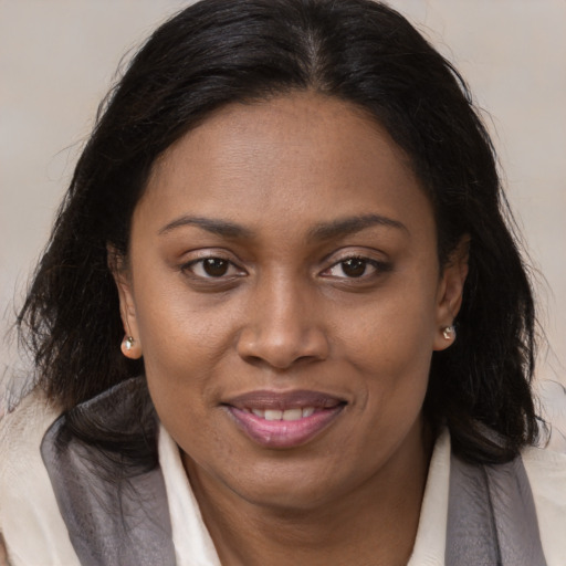 Joyful black young-adult female with medium  brown hair and brown eyes