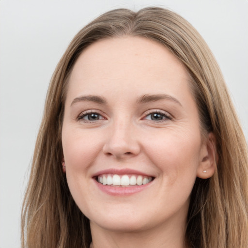 Joyful white young-adult female with long  brown hair and grey eyes