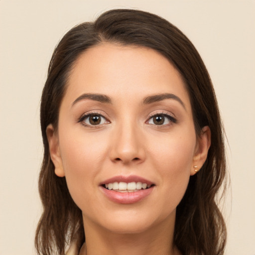 Joyful white young-adult female with long  brown hair and brown eyes