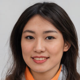 Joyful asian young-adult female with long  brown hair and brown eyes