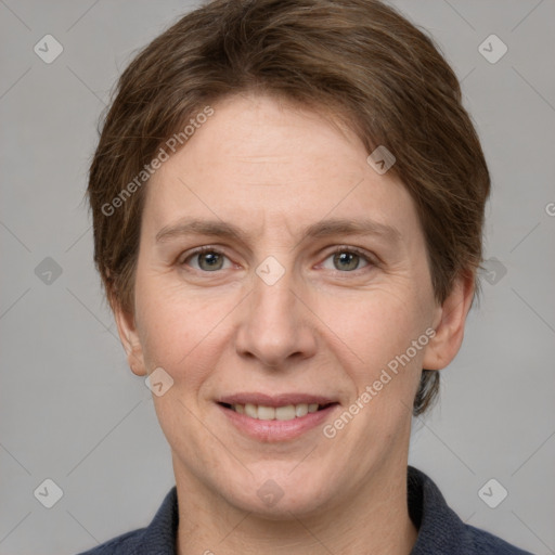 Joyful white adult female with short  brown hair and grey eyes