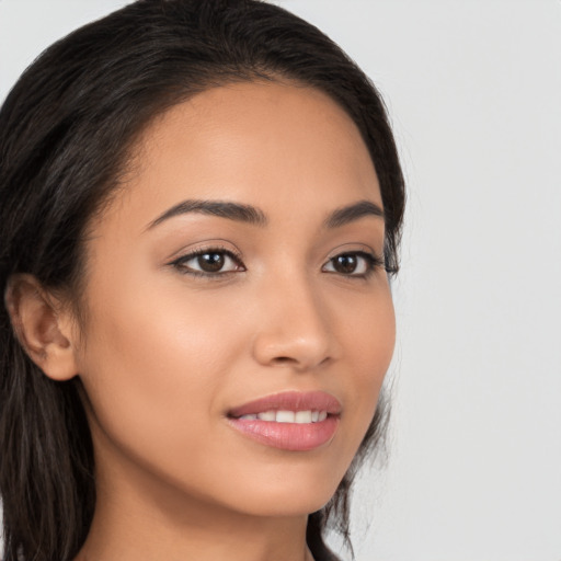 Joyful latino young-adult female with long  brown hair and brown eyes