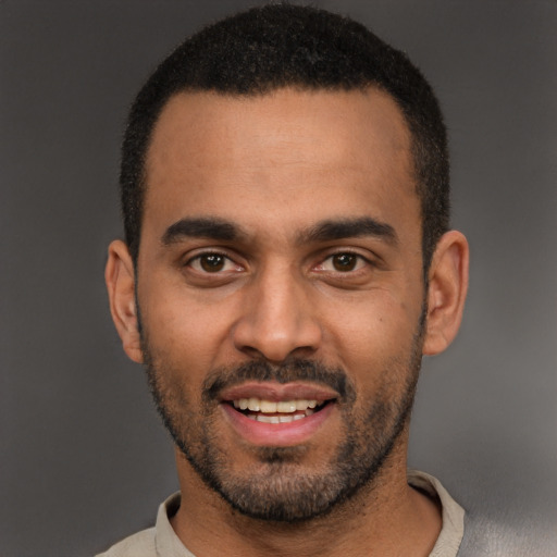 Joyful white young-adult male with short  black hair and brown eyes