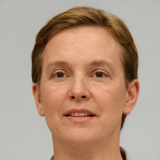 Joyful white adult female with short  brown hair and grey eyes