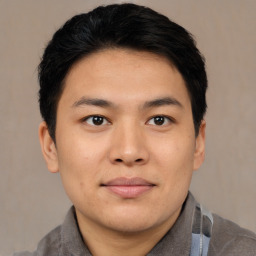 Joyful asian young-adult male with short  black hair and brown eyes