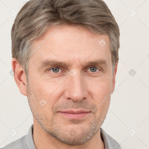 Joyful white adult male with short  brown hair and grey eyes