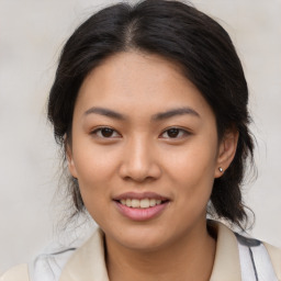 Joyful asian young-adult female with medium  brown hair and brown eyes