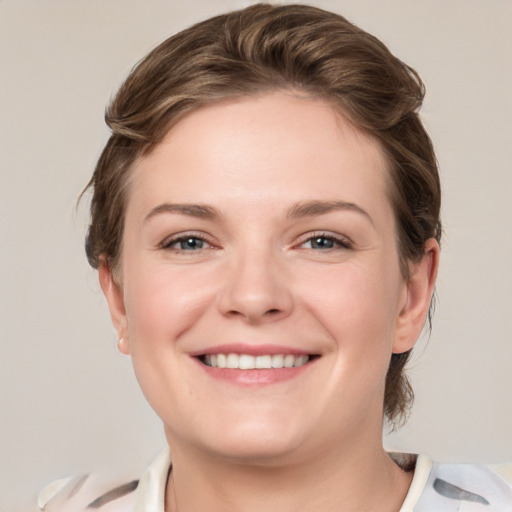 Joyful white young-adult female with medium  brown hair and grey eyes