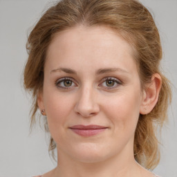 Joyful white young-adult female with medium  brown hair and green eyes