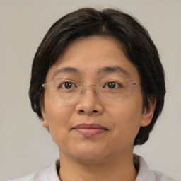 Joyful asian adult female with short  brown hair and brown eyes