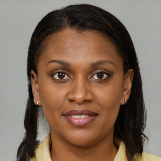 Joyful black young-adult female with medium  brown hair and brown eyes