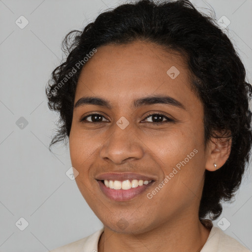 Joyful black young-adult female with medium  brown hair and brown eyes