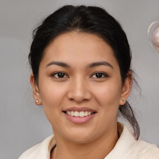 Joyful latino young-adult female with medium  brown hair and brown eyes