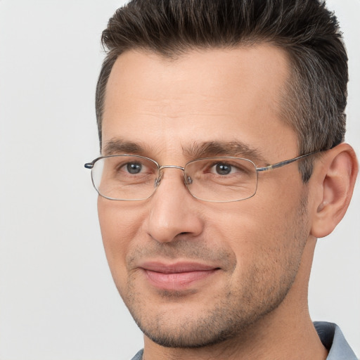 Joyful white adult male with short  brown hair and brown eyes