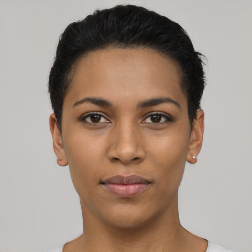 Joyful latino young-adult female with short  black hair and brown eyes