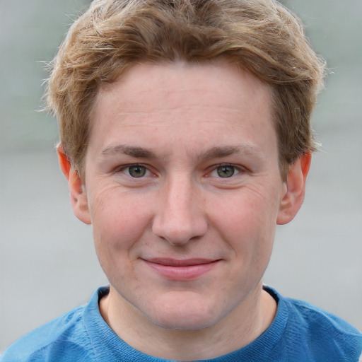 Joyful white young-adult male with short  brown hair and blue eyes