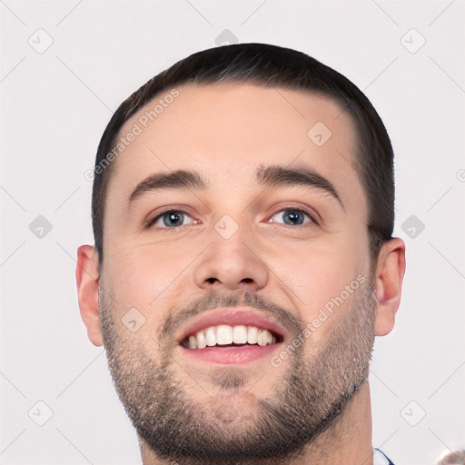 Joyful white young-adult male with short  black hair and brown eyes