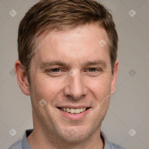 Joyful white adult male with short  brown hair and grey eyes