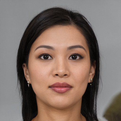 Joyful asian young-adult female with long  black hair and brown eyes