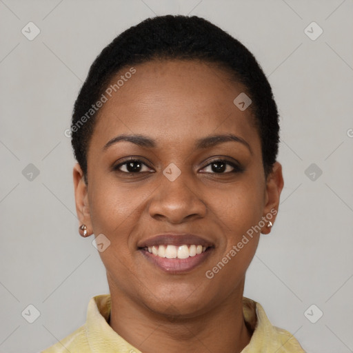 Joyful black young-adult female with short  black hair and brown eyes