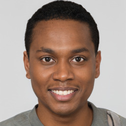 Joyful black young-adult male with short  black hair and brown eyes