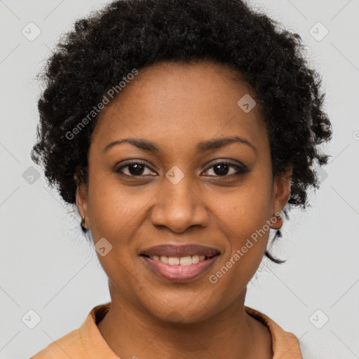 Joyful black young-adult female with short  brown hair and brown eyes