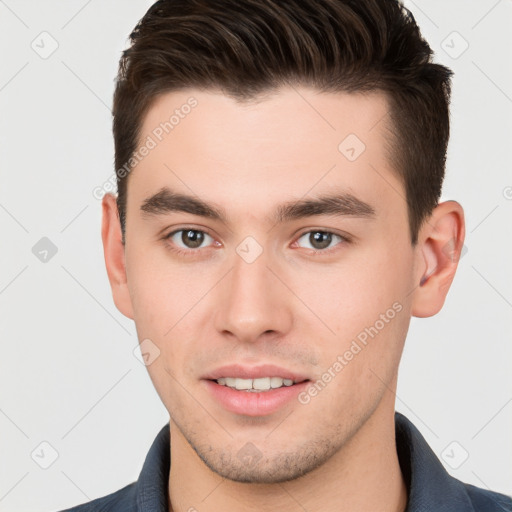 Joyful white young-adult male with short  brown hair and brown eyes