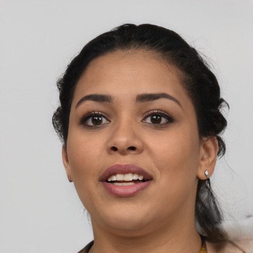 Joyful latino young-adult female with medium  black hair and brown eyes